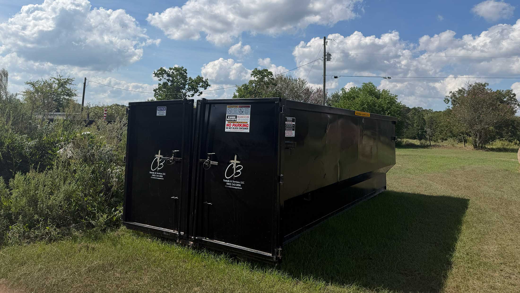 C3 Rentals roll-off dumpster ready for a cleanup project near Frankston, Texas